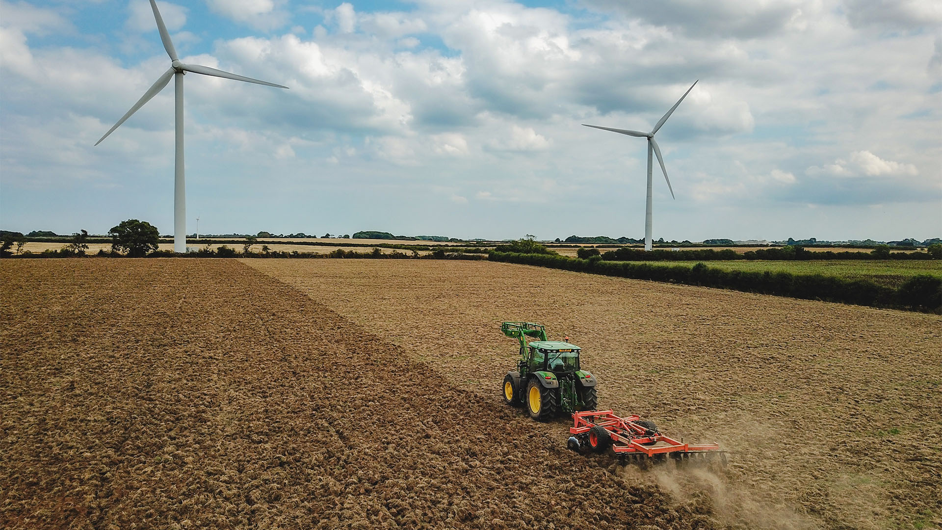 Ploughed field with two wind turbines